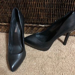 Black leather platform pumps.
